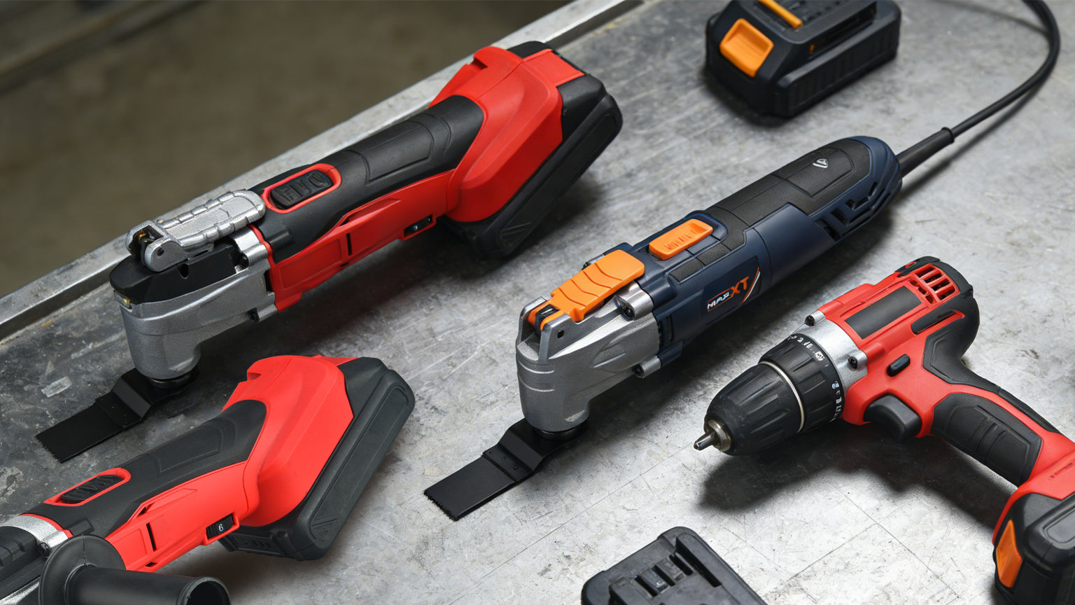 Top-down view comparing corded and cordless oscillating multi-tools with batteries on a workbench